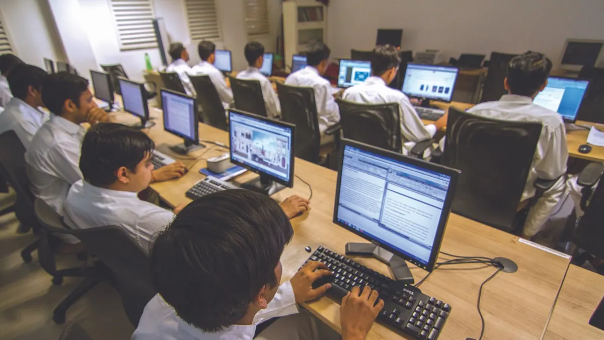 Students working at computers in an SSSIHL lab