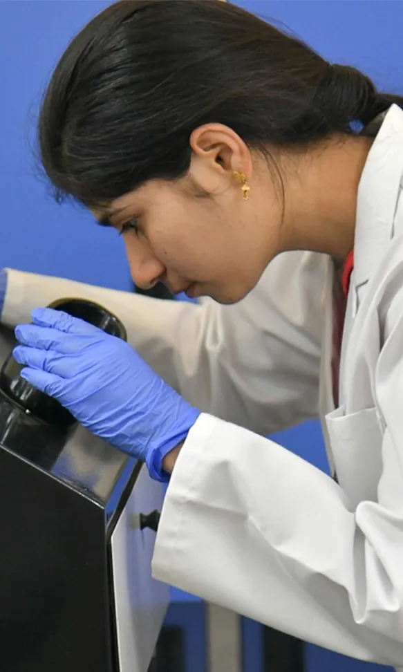 A researcher working with lab equipment at SSSIHL
