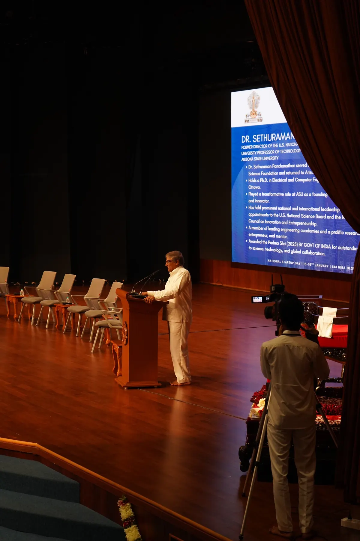 Dr. Sethuraman Panchanathan at the podium with his introduction on screen