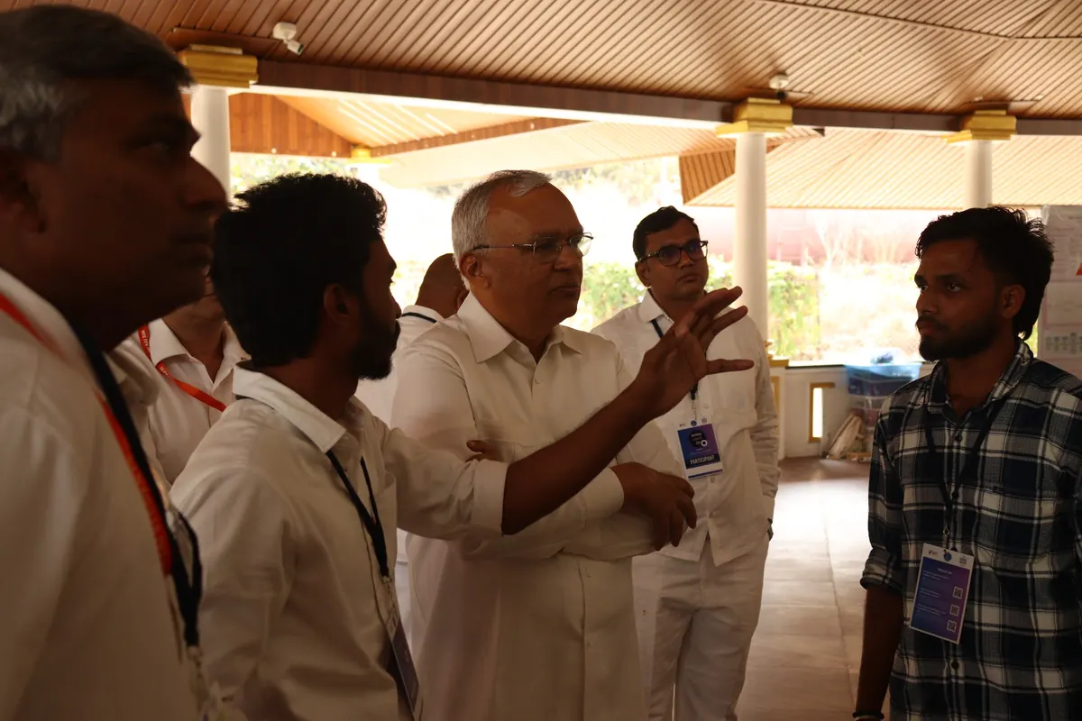 Visitors discussing a student poster at the Startup Day poster presentation