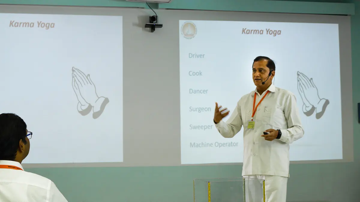 A presenter leading a workshop session at SSSIHL